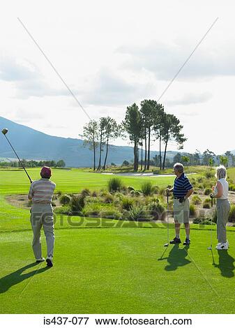 Friends playing golf View Large Photo Image Stock Photo - Friends playing golf. Fotosearch