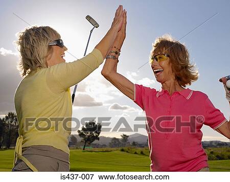 Women golfers doing a high five View Large Photo Image Stock Photo - Women golfers doing a high five. Fotosearch