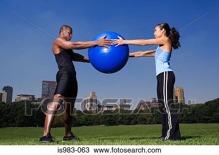 Man and woman holding exercise ball View Large Photo Image Stock Image - Man and woman holding exercise ball. Fotosearch