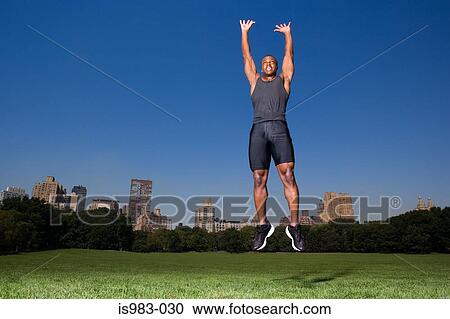 Stock Image - Man jumping in the park. Fotosearch