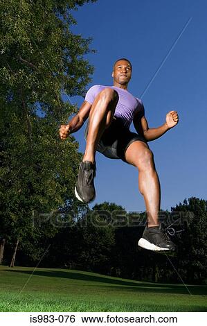 Man jumping in the park View Large Photo Image Stock Photograph - Man jumping in the park. Fotosearch
