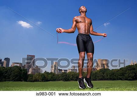 Man skipping in central park View Large Photo Image Stock Image - Man skipping in central park. Fotosearch