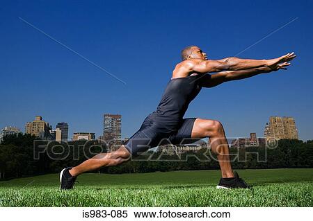 Man stretching in central park View Large Photo Image Stock Photography - Man stretching in central park. Fotosearch