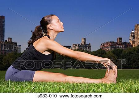 Woman stretching in central park View Large Photo Image Stock Image - Woman stretching in central park. Fotosearch