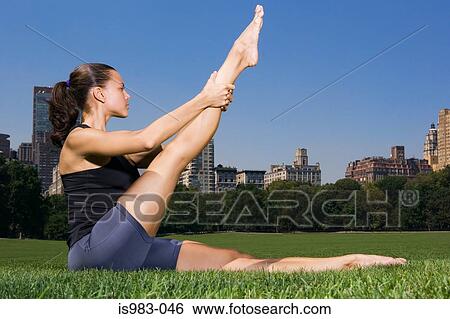 Woman stretching in the park View Large Photo Image Stock Photograph - Woman stretching in the park. Fotosearch
