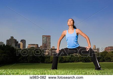 Woman warming up in the park View Large Photo Image Stock Image - Woman warming up in the park. Fotosearch