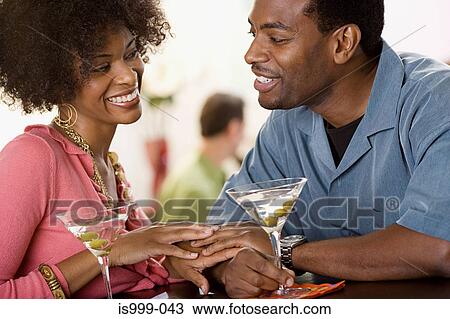 Couple flirting over cocktails View Large Photo Image Stock Image - Couple flirting over cocktails. Fotosearch
