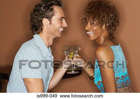 Couple having martinis View Large Photo Image Stock Photo - Couple having martinis. Fotosearch