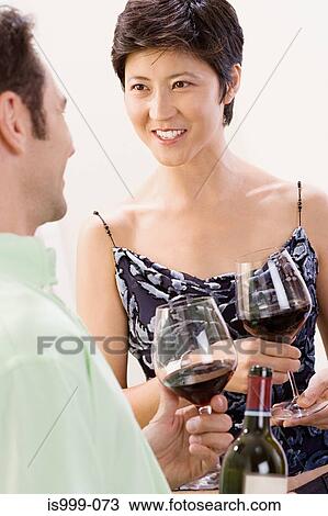 Couple talking at a party View Large Photo Image Stock Image - Couple talking at a party. Fotosearch