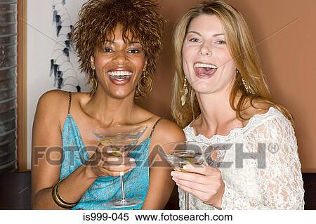 Stock Photography - Friends enjoying cocktails. Fotosearch