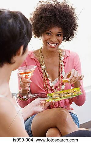 Friends having canapes and cocktails View Large Photo Image Picture - Friends having canapes and cocktails. Fotosearch