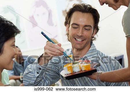 Friends having sushi View Large Photo Image Stock Image - Friends having sushi. Fotosearch