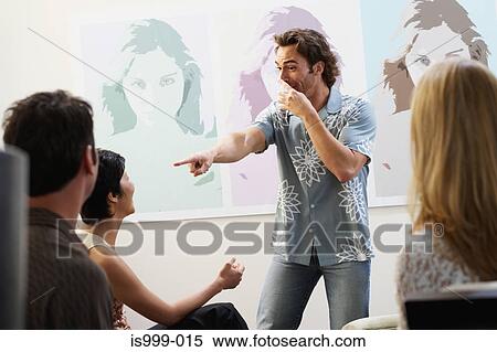 Stock Photography - Friends playing charades. Fotosearch