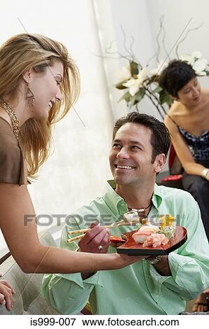 Stock Photo - Hostess with sushi canapes. Fotosearch