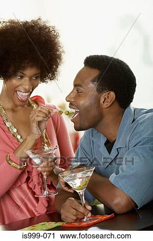 Woman feeding olives to man View Large Photo Image Stock Image - Woman feeding olives to man. Fotosearch