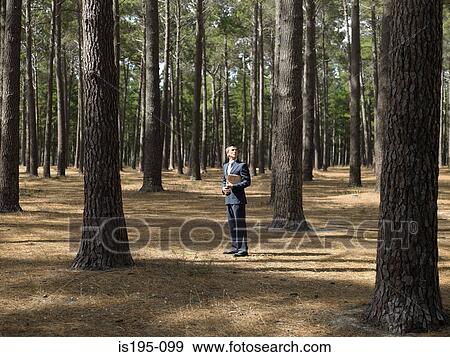 Stock Photo - Businessman in forest. Fotosearch