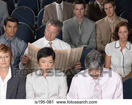 Businessman reading during presentation View Large Photo Image Stock Image - Businessman reading during presentation. Fotosearch