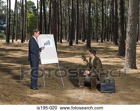 Businessmen holding meeting in forest View Large Photo Image Stock Image - Businessmen holding meeting in forest. Fotosearch
