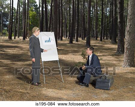 Office workers holding a meeting in forest View Large Photo Image Picture - Office workers holding a meeting in forest. Fotosearch