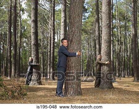 Stock Photo - Office workers hugging trees. Fotosearch