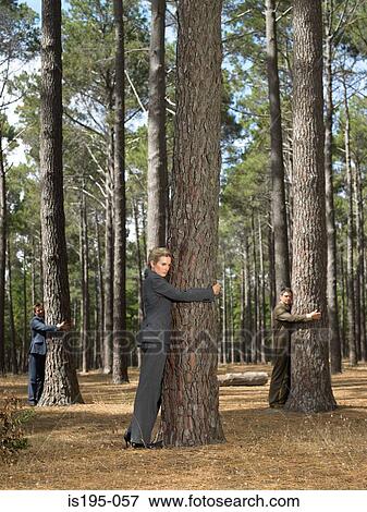 Office workers hugging trees View Large Photo Image Stock Photo - Office workers hugging trees. Fotosearch