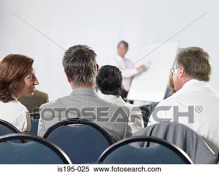Office workers listening to a presentation View Large Photo Image Stock Photography - Office workers listening to a presentation. Fotosearch