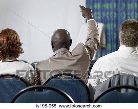 Stock Photography - Office workers listening to a presentation. Fotosearch