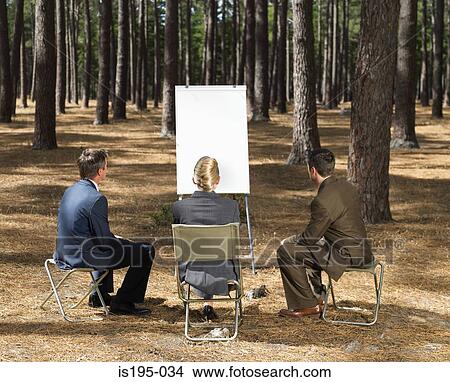 Office workers with flipchart in forest View Large Photo Image Picture - Office workers with flipchart in forest. Fotosearch