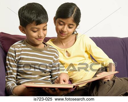 Brother and sister sitting on sofa View Large Photo Image Stock Photography - Brother and sister sitting on sofa. Fotosearch