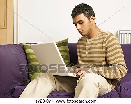 Man using a laptop computer View Large Photo Image Stock Photo - Man using a laptop computer. Fotosearch