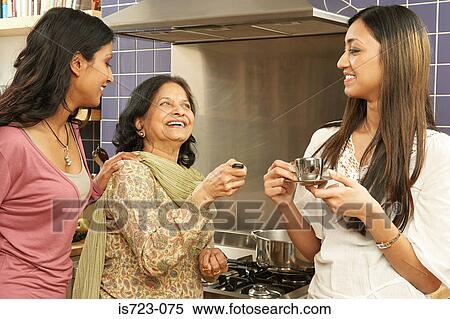 Mother and daughters in kitchen View Large Photo Image Stock Photography - Mother and daughters in kitchen. Fotosearch