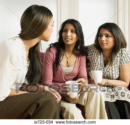 Women talking on sofa View Large Photo Image Picture - Women talking on sofa. Fotosearch