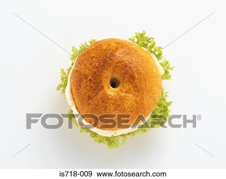 Stock Photo - Bagel with cream cheese and salad. Fotosearch