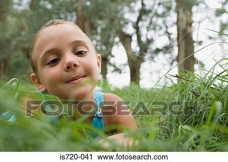 Stock Image - Curious looking girl in a field. Fotosearch