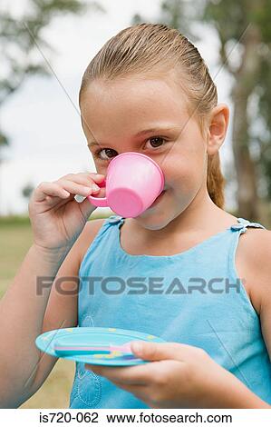 Girl drinking from a plastic cup View Large Photo Image Stock Image - Girl drinking from a plastic cup. Fotosearch