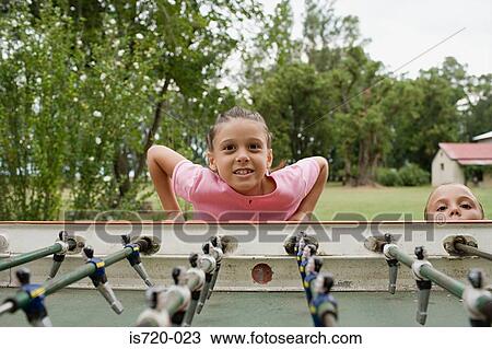 Girl playing table football View Large Photo Image Stock Image - Girl playing table football. Fotosearch