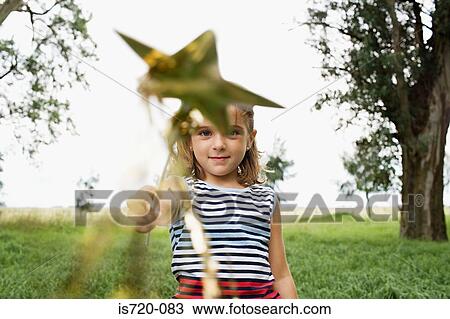 Girl playing with a wand View Large Photo Image Stock Image - Girl playing with a wand. Fotosearch