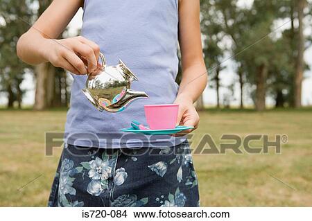 Girl pretending to pour tea View Large Photo Image Picture - Girl pretending to pour tea. Fotosearch