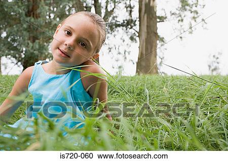 Girl sitting in a field View Large Photo Image Stock Image - Girl sitting in a field. Fotosearch