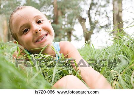Girl sitting in grass View Large Photo Image Stock Photograph - Girl sitting in grass. Fotosearch