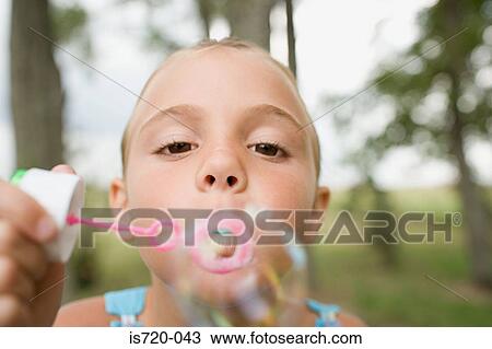 Girl using a bubble wand View Large Photo Image Stock Image - Girl using a bubble wand. Fotosearch