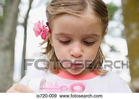 Girl using a bubble wand View Large Photo Image Stock Photo - Girl using a bubble wand. Fotosearch