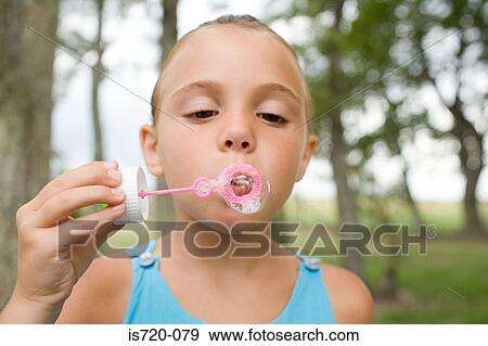 Girl using a bubble wand View Large Photo Image Stock Photo - Girl using a bubble wand. Fotosearch