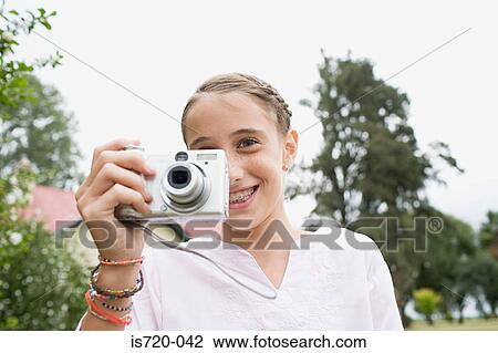 Girl using a digital camera View Large Photo Image Stock Image - Girl using a digital camera. Fotosearch
