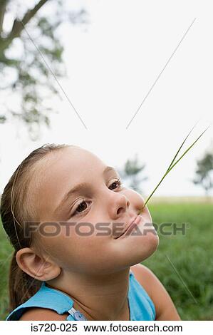 Girl with a piece of straw in her mouth View Large Photo Image Stock Photography - Girl with a piece of straw in her mouth. Fotosearch