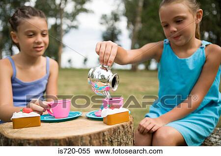 Girls having a tea party in field View Large Photo Image Stock Photography - Girls having a tea party in field. Fotosearch