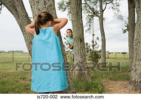 Girls playing hide and seek View Large Photo Image Stock Image - Girls playing hide and seek. Fotosearch