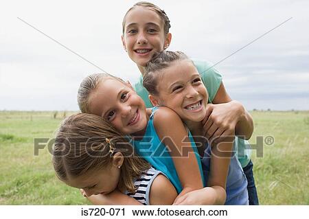 Stock Image - Girls playing in a field. Fotosearch