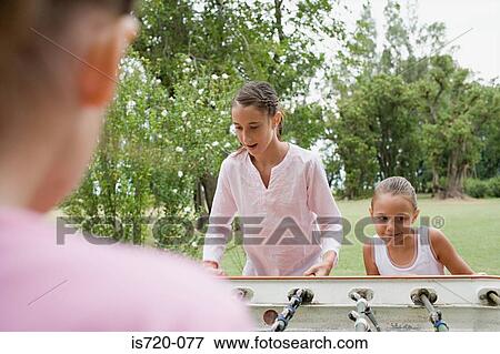 Girls playing table football View Large Photo Image Stock Photo - Girls playing table football. Fotosearch