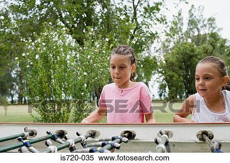 Girls playing table football View Large Photo Image Stock Photography - Girls playing table football. Fotosearch